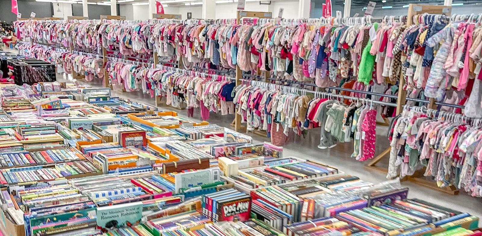 table with books, racks with clothes